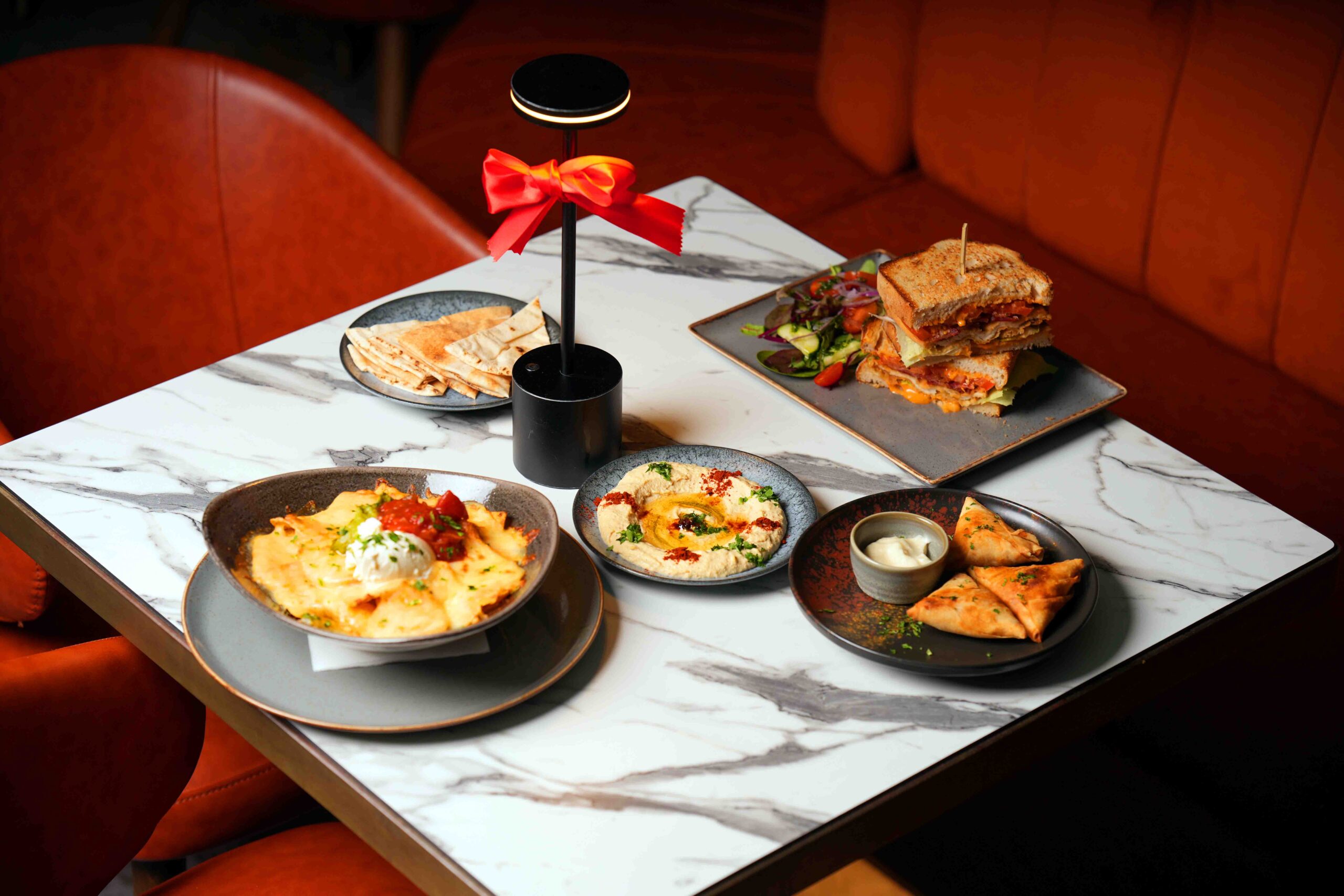 Starter platter of nachos, hummus, pitta and a stacked sandwich at Citi Terrace