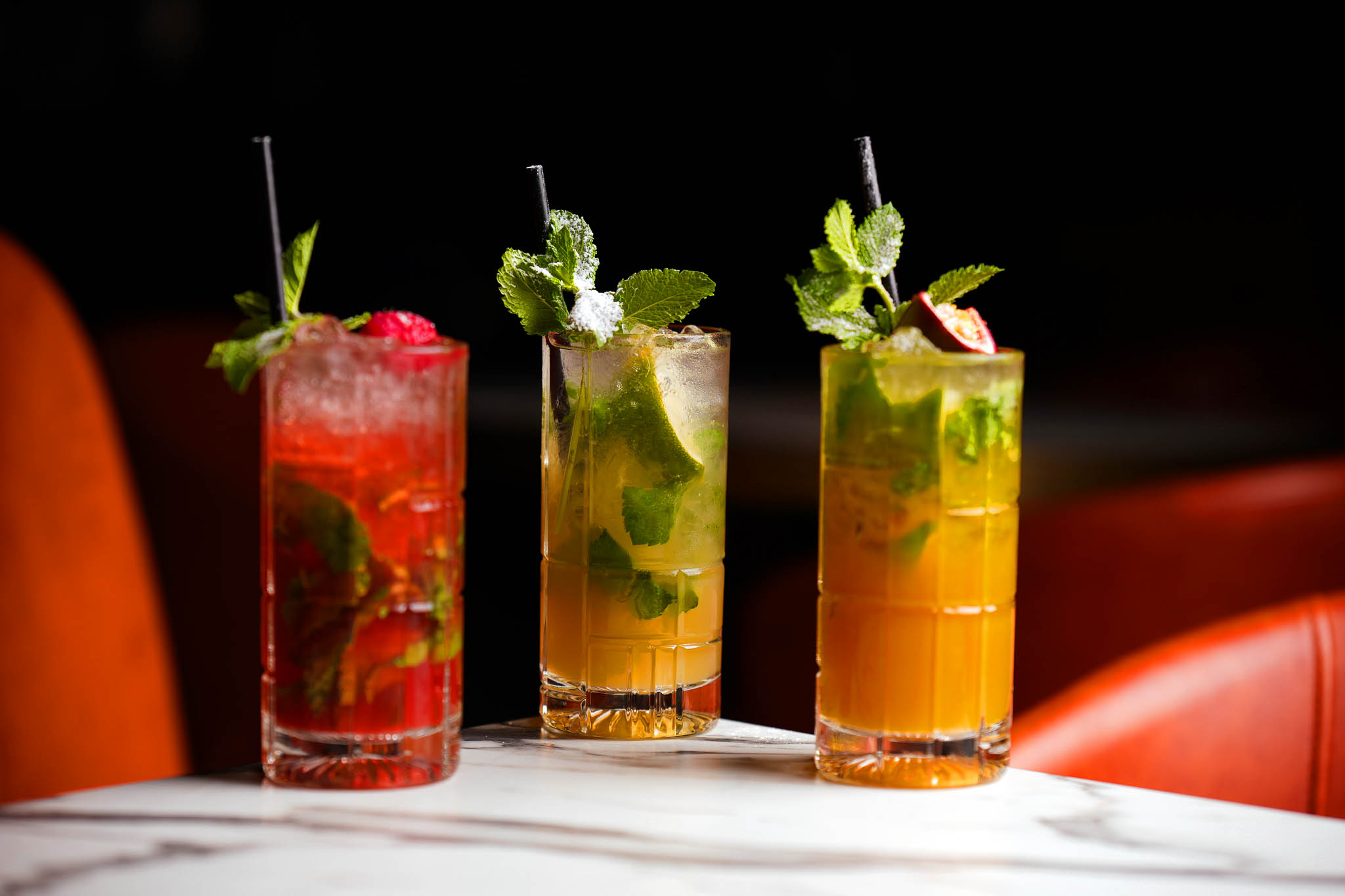 Three fruit-garnished cocktails at Citi Terrace