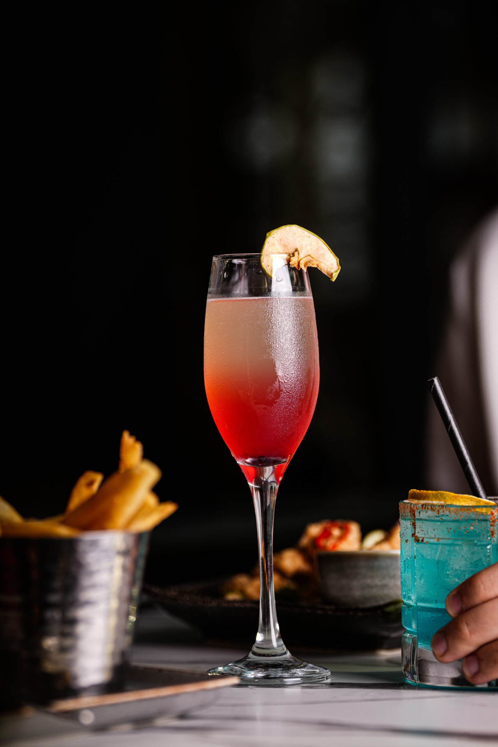 A rose cocktail garnished with dried apple at Citi Terrace